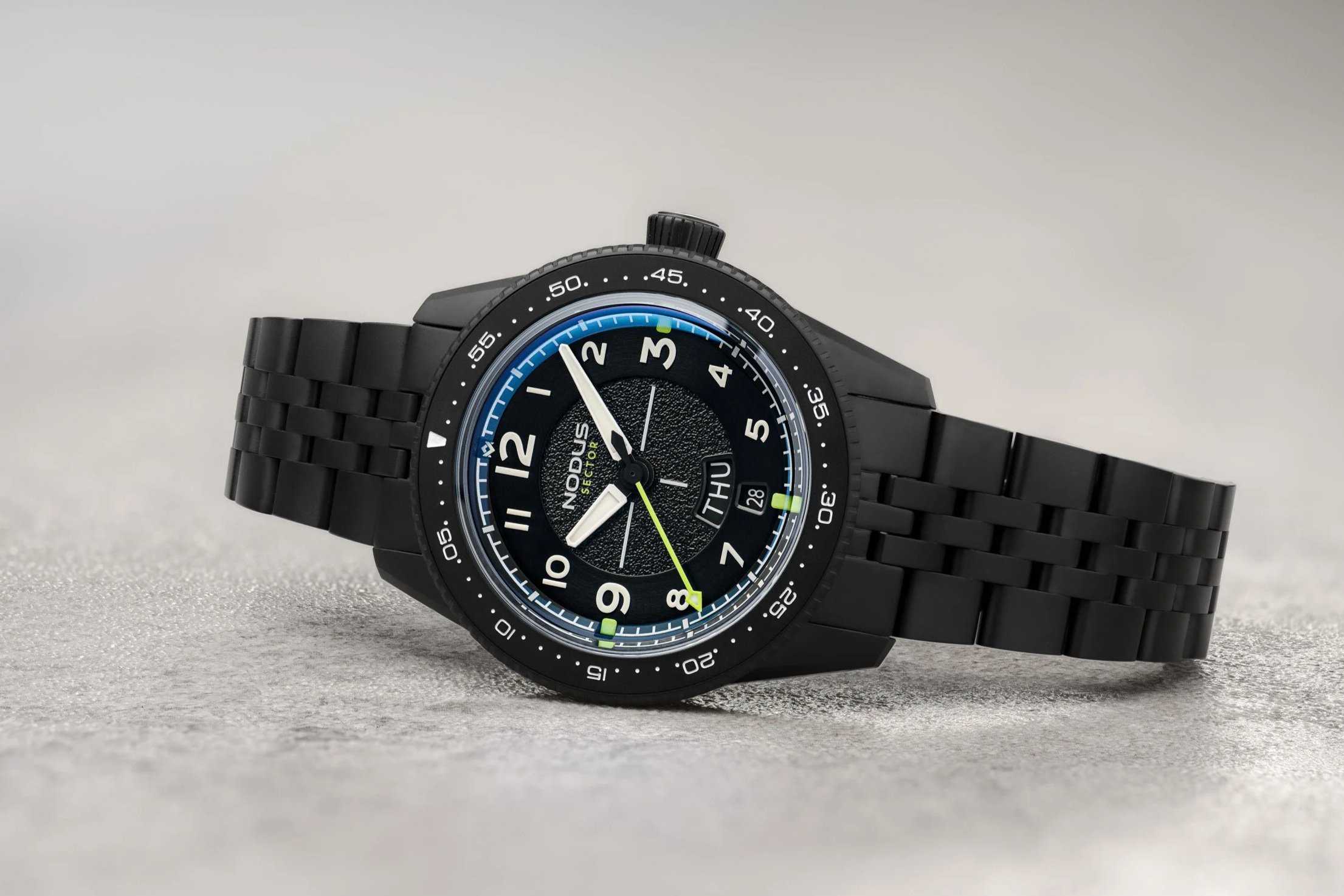 Nodus Sector II Pilot DLC watch with black bracelet and green-accented dial on display