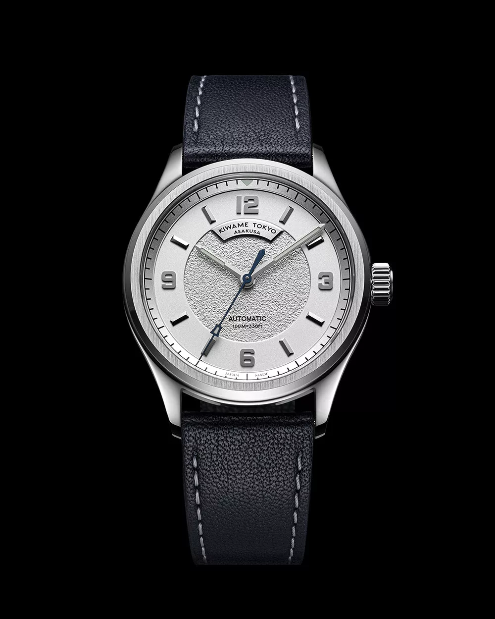 Front view of automatic wristwatch with white dial, Arabic numerals, stainless steel case, and leather strap
