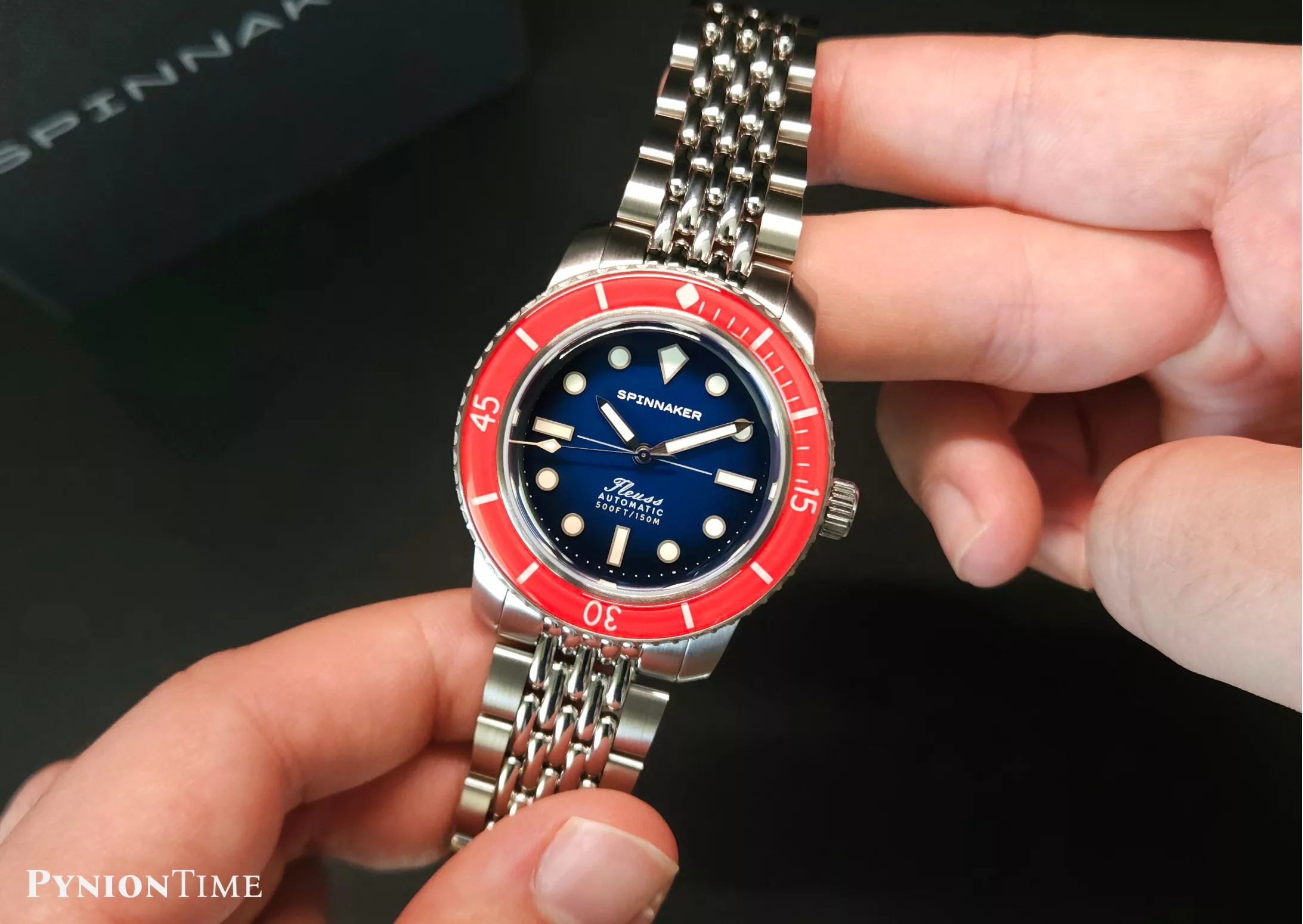 The Spinnaker Fleuss 40 Royal Splash has a red bezel and a blue dial