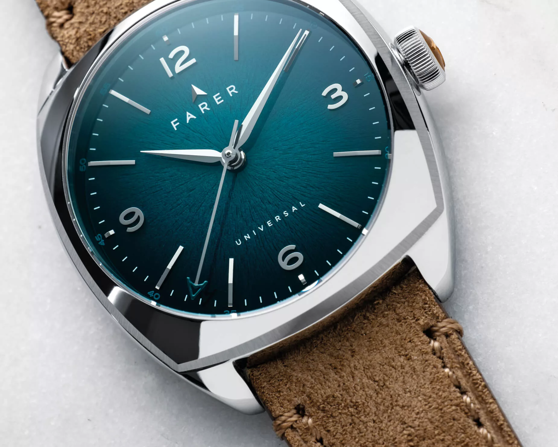 The Farer Belzoni has a bold teal dial featuring a radial bark-like texture