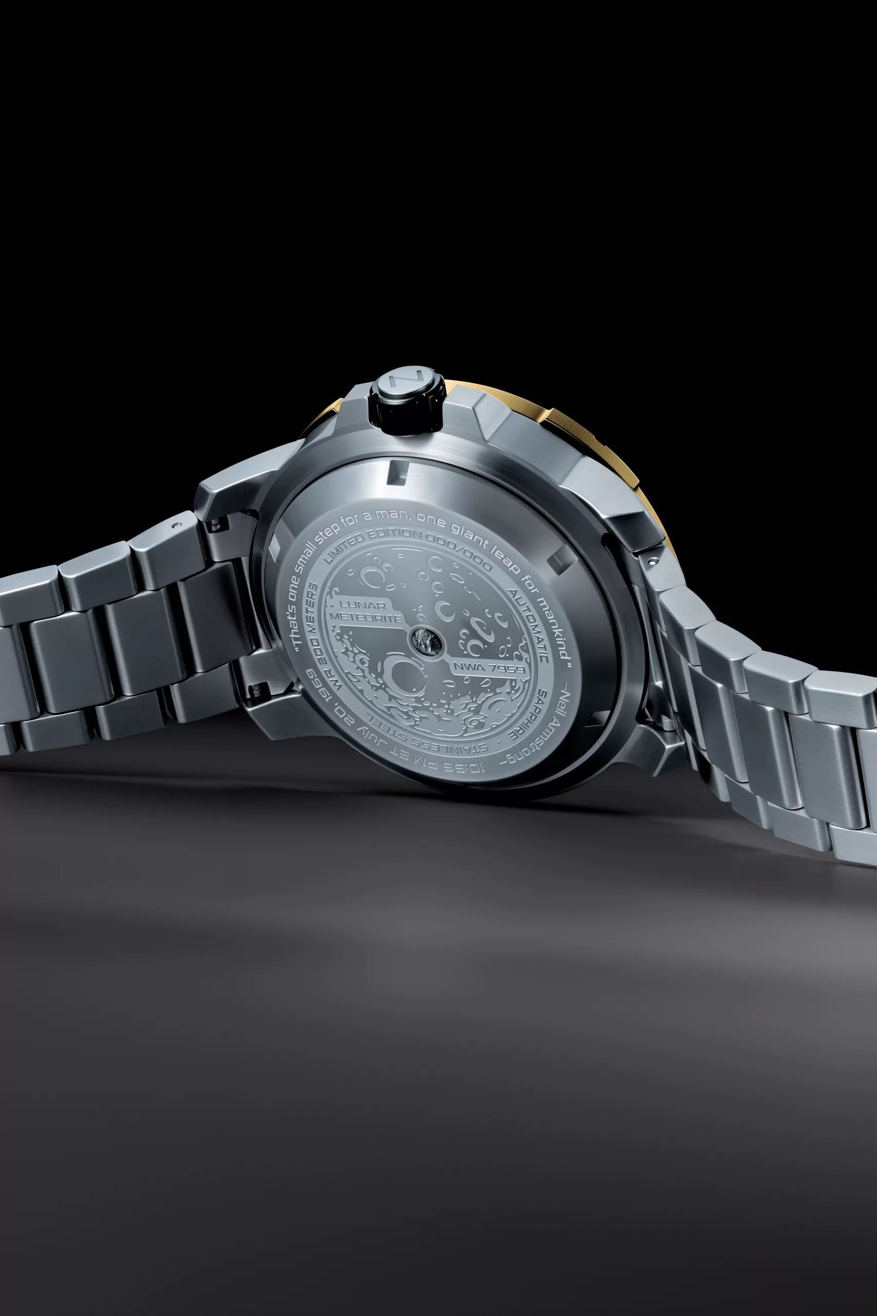 It features an engraved Armstrong quote on the rear