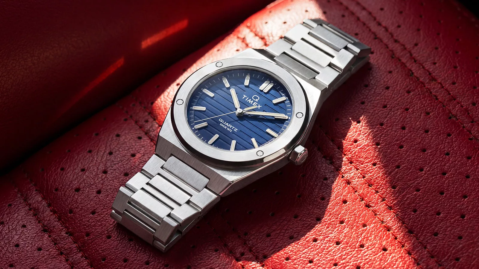 The Q Timex Marbella 40.5mm has a circular-brushed bezel with four exposed polished bolts