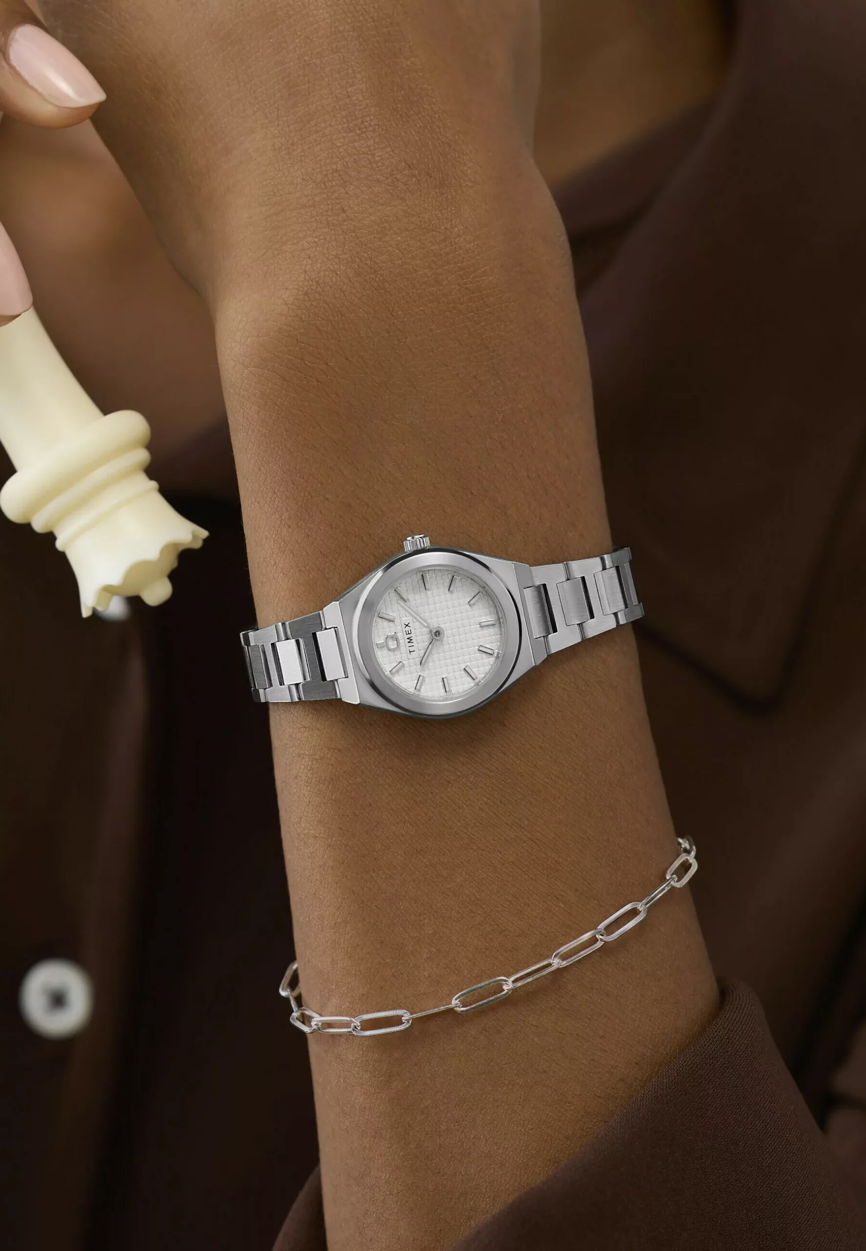 The Timex Q Continental Mini's textured dial and luminous markers on its 24mm steel case