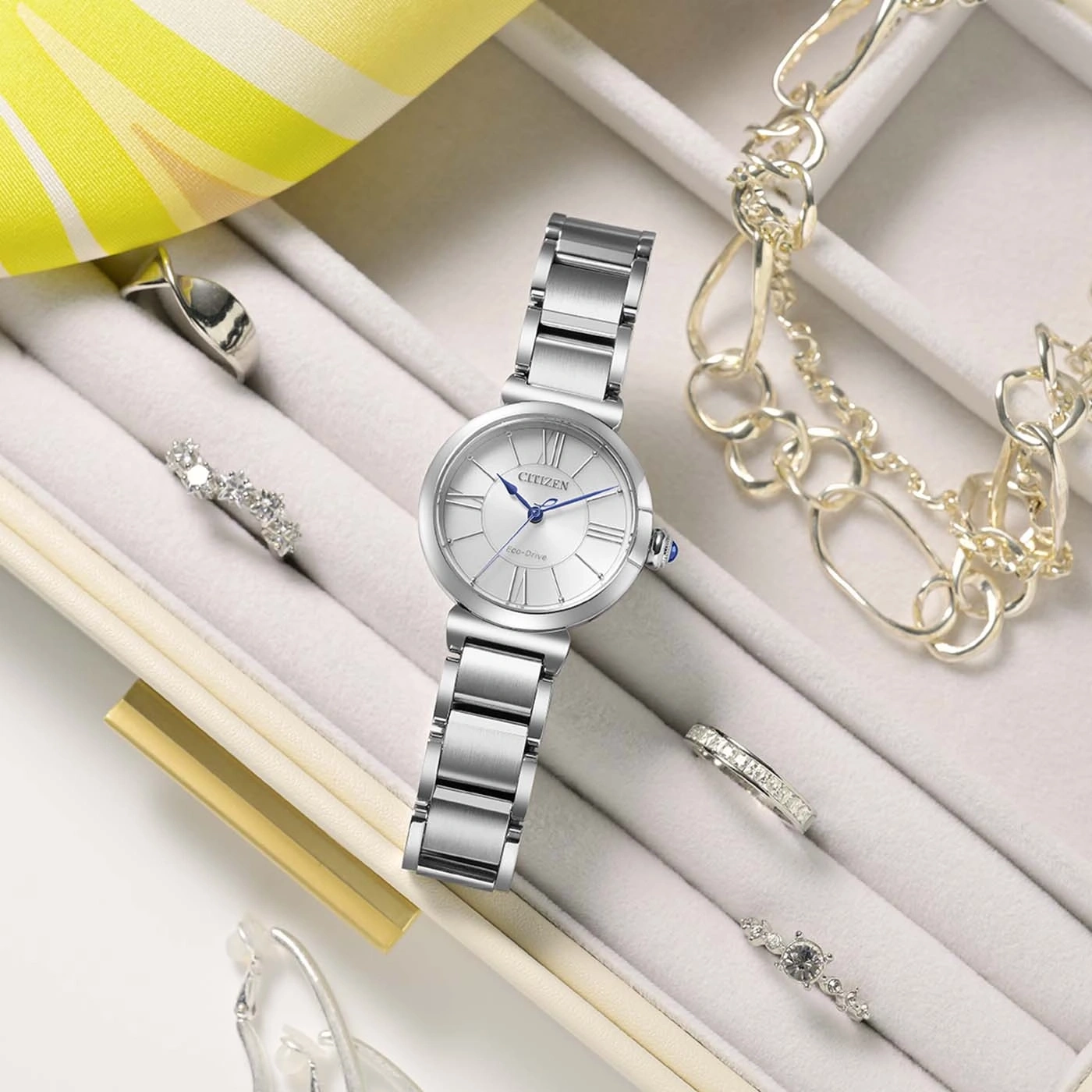 The Citizen Lady EM1070-83A's spherical sapphire crystal catching the light on its steel case