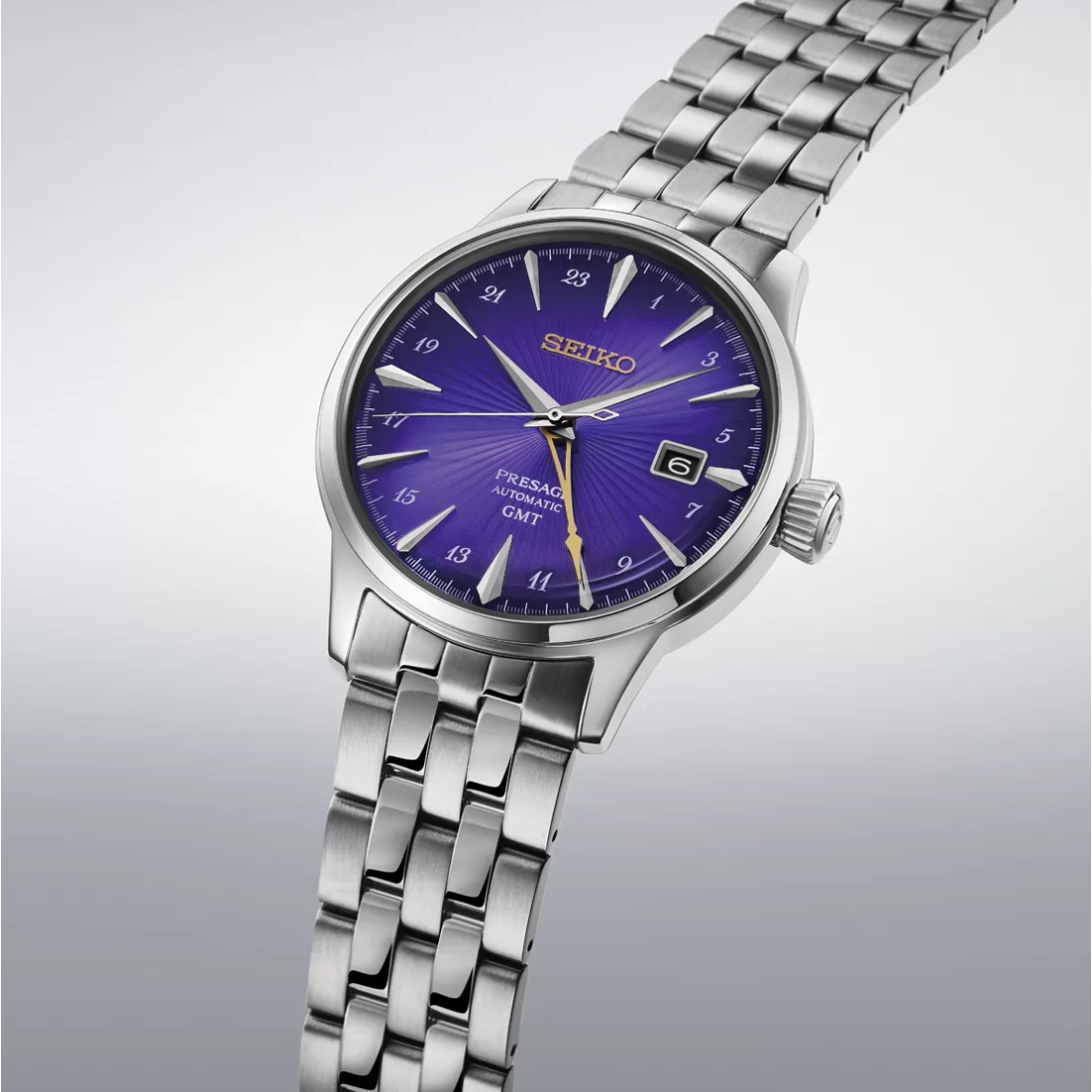 The Cocktail Time HCB006 has a deep translucent purple dial with a radial pattern and gold-colored GMT hand