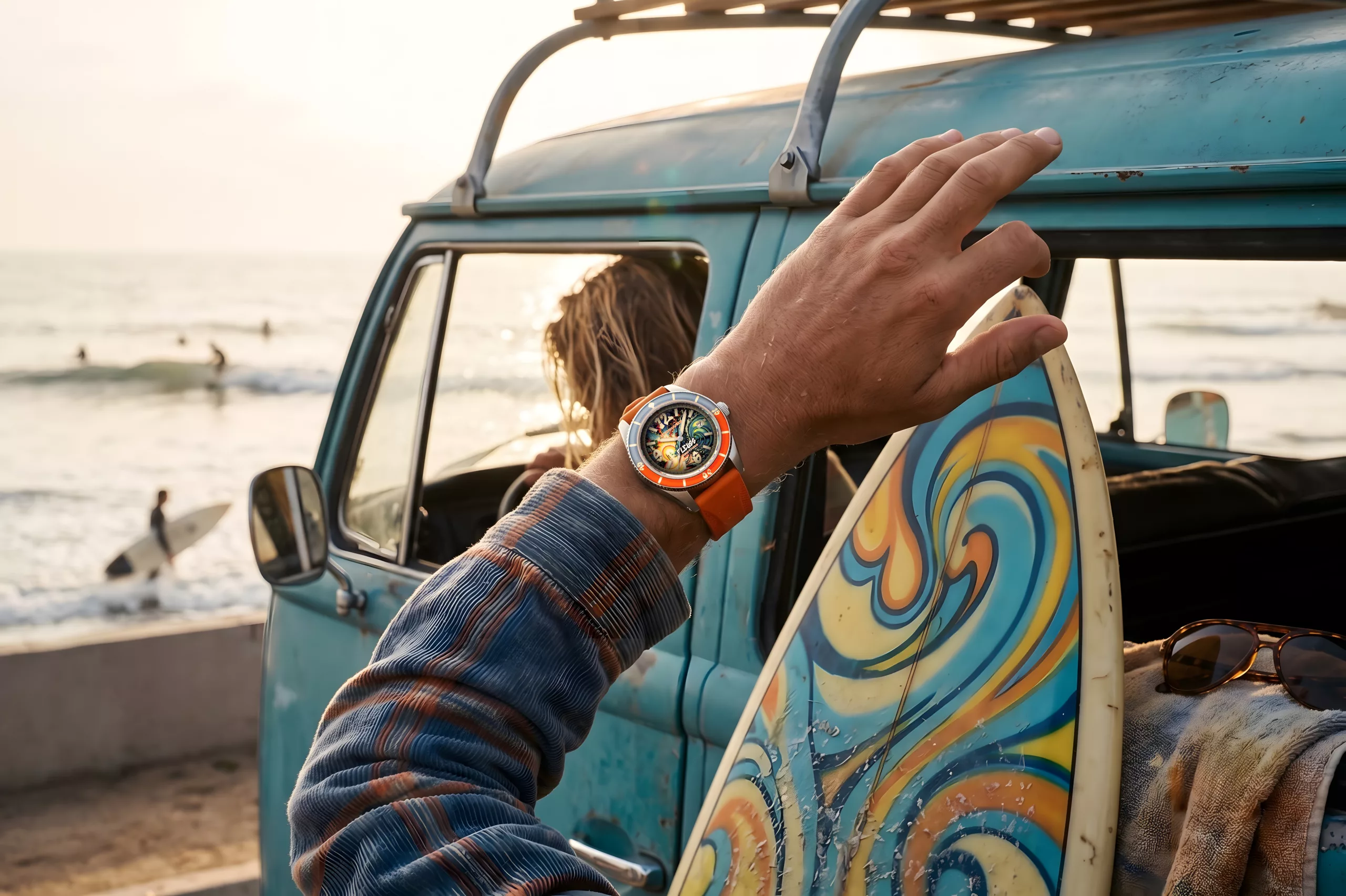 The dial combines blues and oranges across the face and bezel to represent sunrise and sunset over the ocean