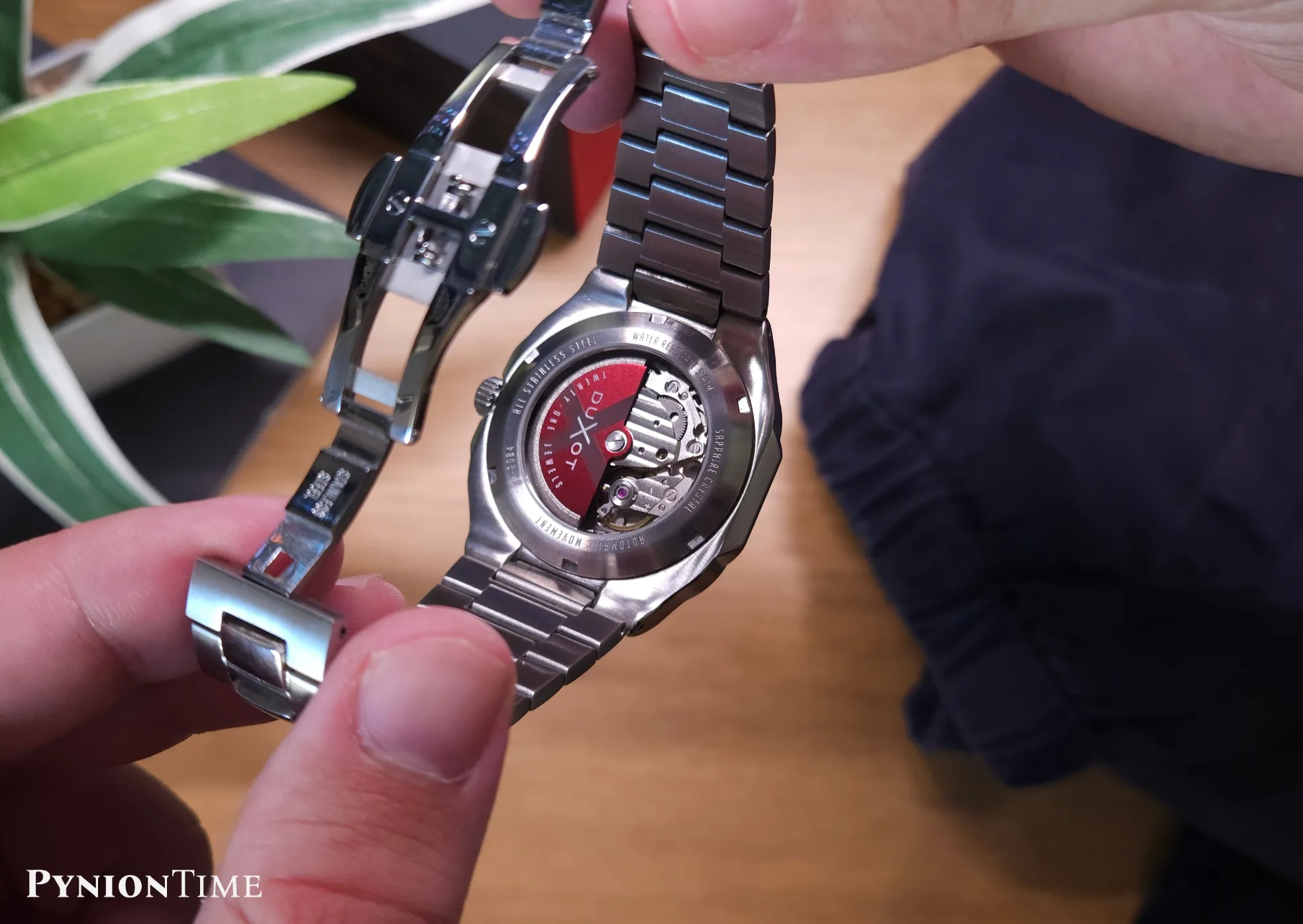 It uses a Miyota 8247 automatic, seen through the exhibition caseback with a red Duxot rotor