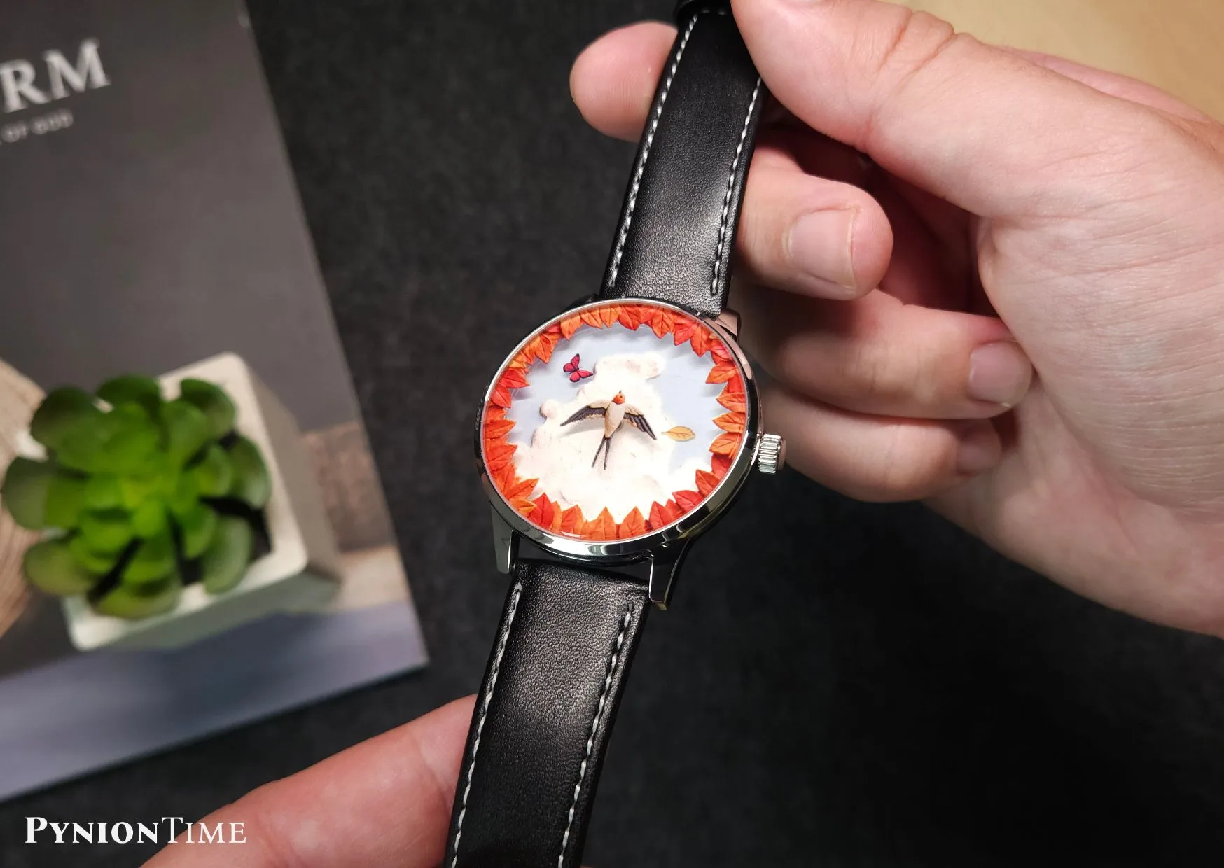 It features no seconds hand, numerals or markers, so the artwork fills the whole dial