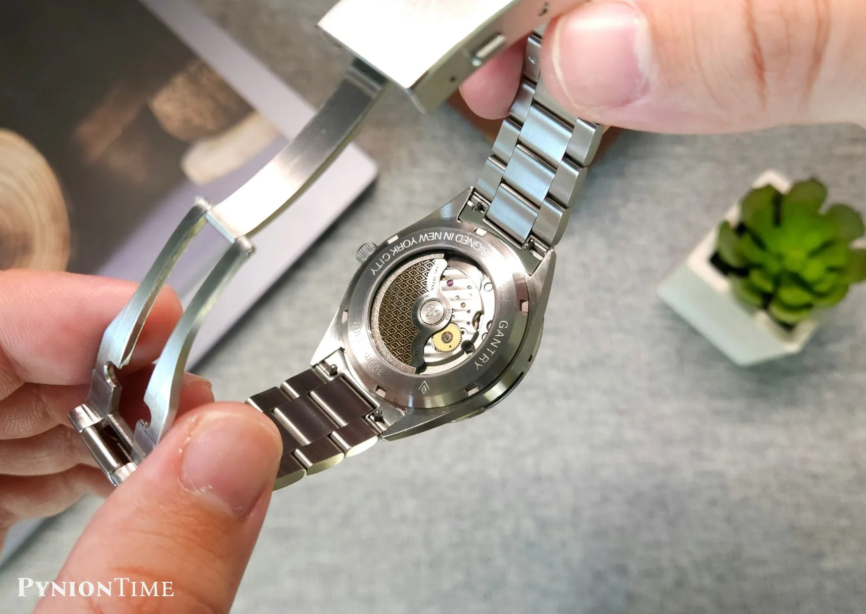 It uses a hand-wound Sellita SW210-1b in production, while this prototype runs a Miyota 9039