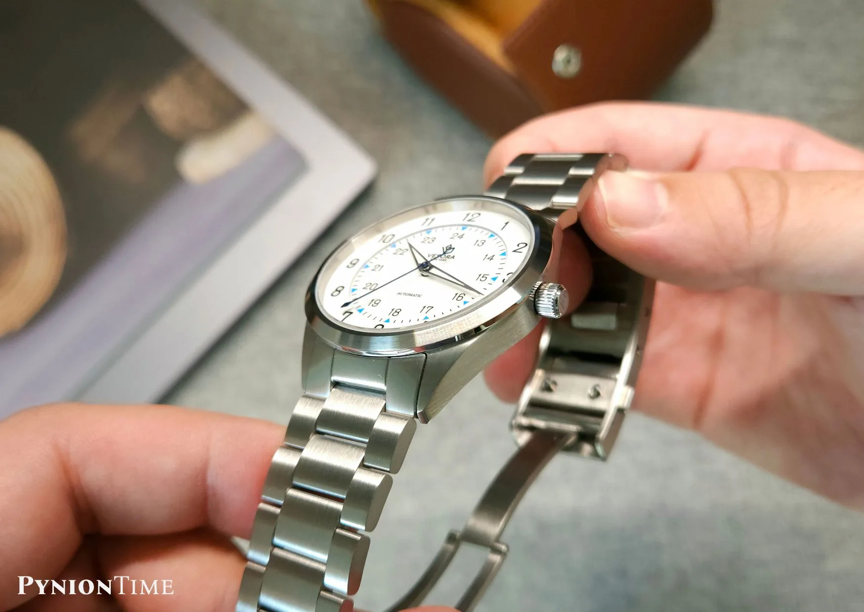 It features a double-domed sapphire crystal with anti-reflective coating over the white enamel dial